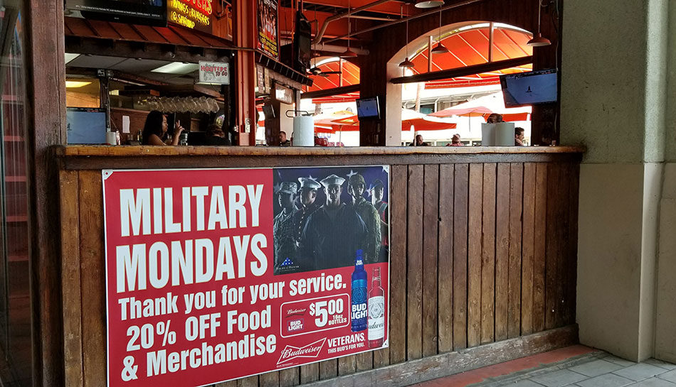 Big sign in the front of the store showing military deals for a branches of the military.